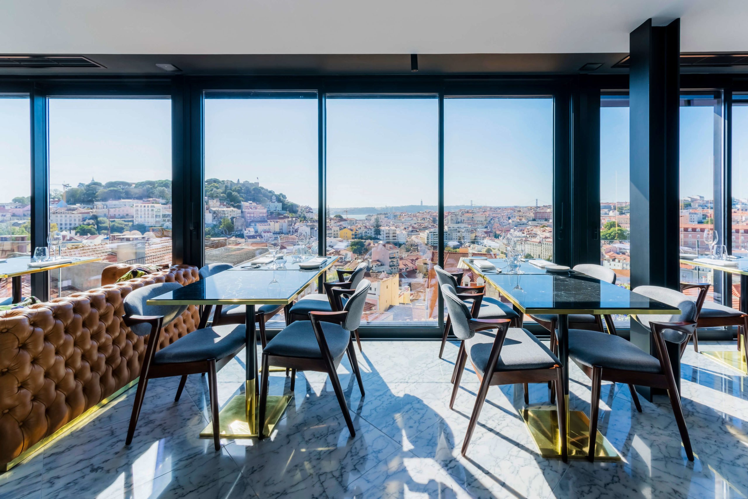 The restaurant's main room, with magnificent windows overlooking the city of Lisbon.